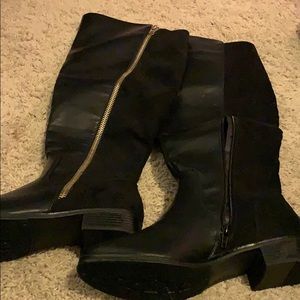 Black knee length boots.